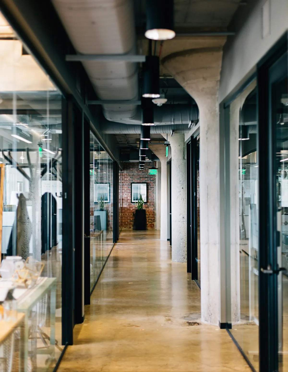Office corridor with glazed partitions and exposed ceiling